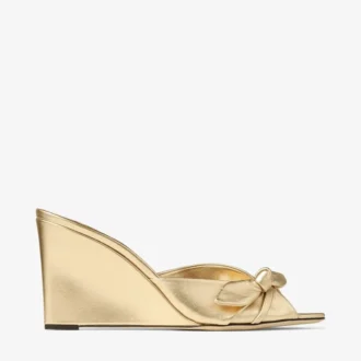 Livi Wedge 85 Goldfarbene Mules aus metallischem Nappaleder mit Keilabsatz und Schleife