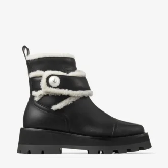 Meena Flache schwarze Stiefeletten aus glänzendem Kalbsleder mit Lammfell