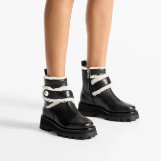 Meena Flache schwarze Stiefeletten aus glänzendem Kalbsleder mit Lammfell